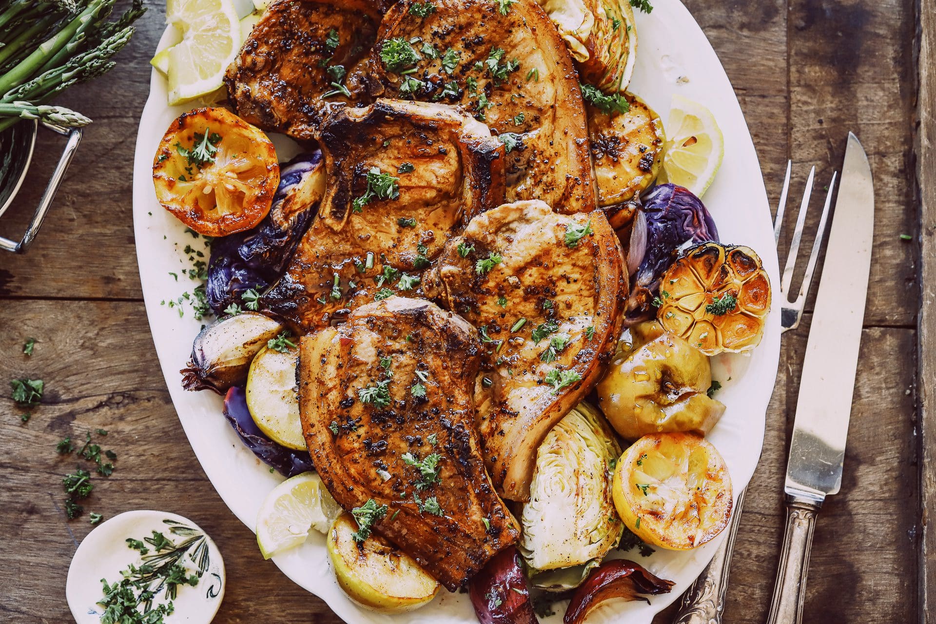 Platter of pork chops with grilled apple and cabbage wedges